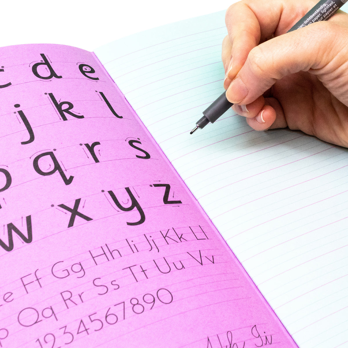 Handwriting Practice Book With A Pen Writing In The Silvine SEN Handwriting Book Blue Tinted Papers For Classrooms On A White Background