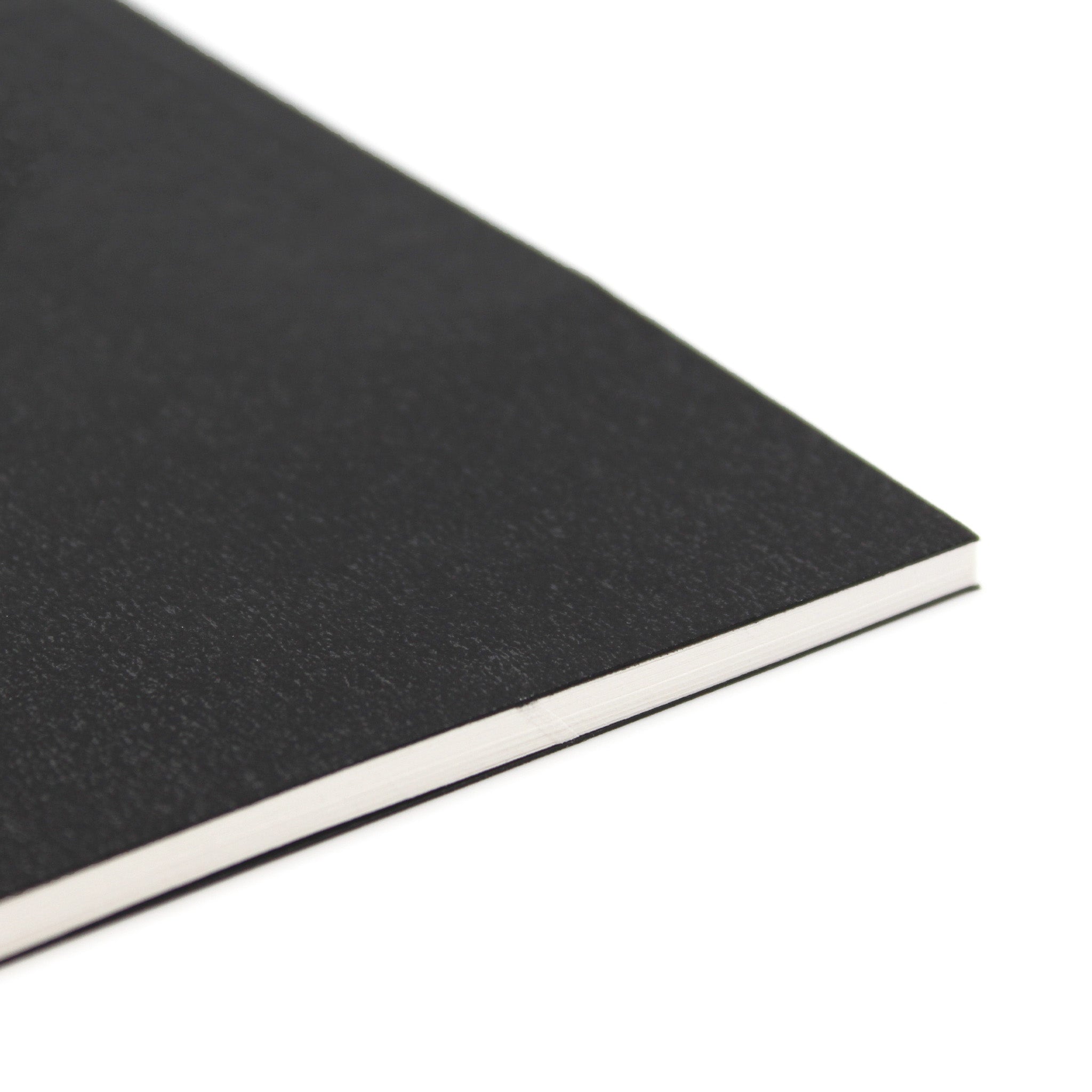 Close Up Corner Of A3 Field Black Sketchbook 140gsm Paper On A White Background
